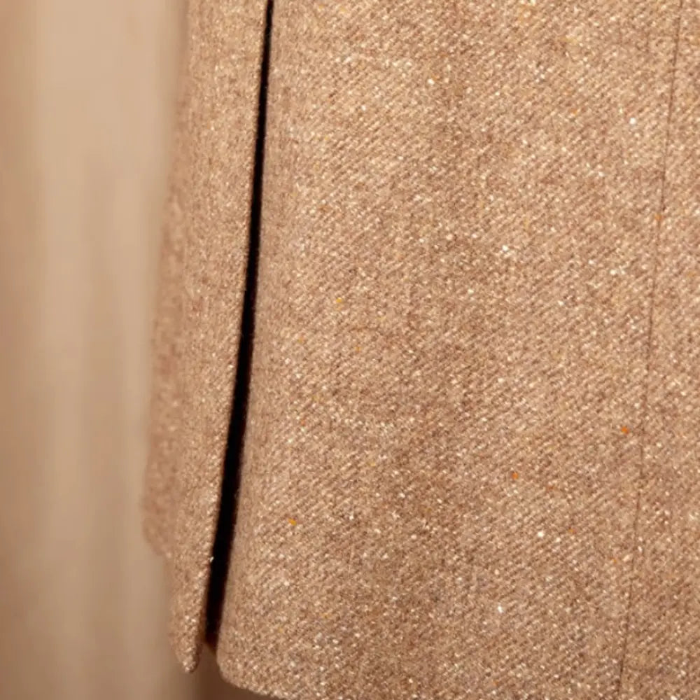 Close-up of a textured beige fabric with a vertical seam.